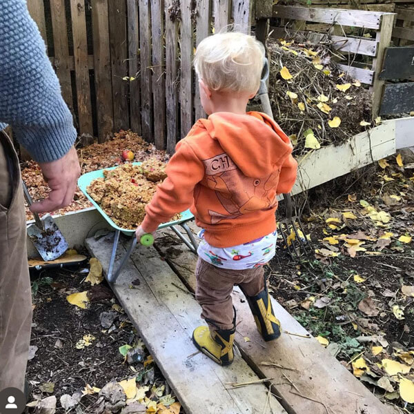 Child making compost at Tollesbury Apple Day