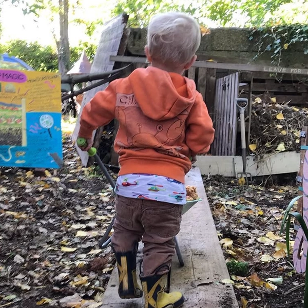 Child making compost at Apple Day for TCP